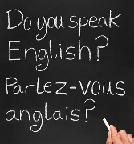 A teacher writing do you speak english in French.